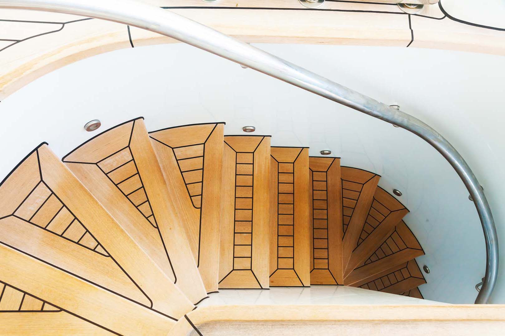 Spiral teak steps inside a luxury yacht.